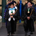 Faculty members walking down the aisle