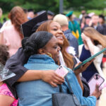 Student hugging family