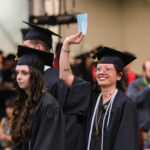 Student waving to the crowd
