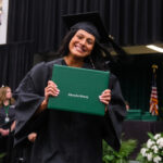 Student smiling after receiving their degree