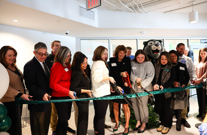 Karen Riley cuts the ribbon with other contributors to the new Success Center