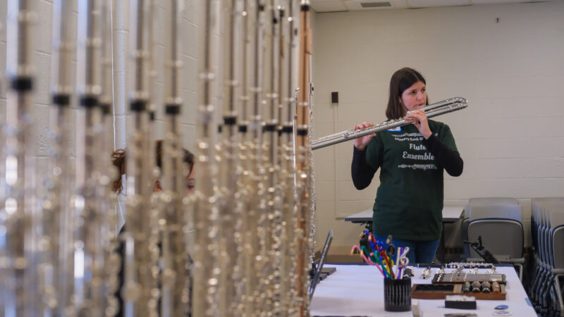 Cadence Durnell, a student, tests a bass flute