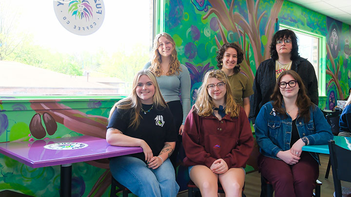 From left (front row), Krista Polanofsky, Camille Bupp, Riley Lennon, (back row) Megan Evans, Alex Zieg and Link Berger are the SRU art students who painted a mural in the Fuzzy Monkey Coffee Co. in Slippery Rock.