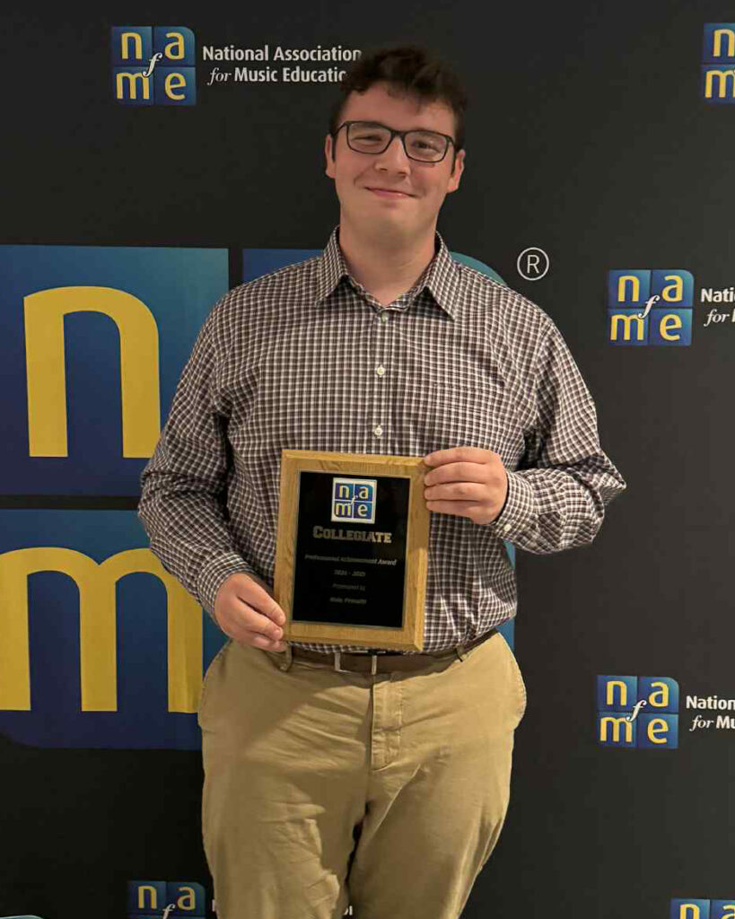 Man holding plaque