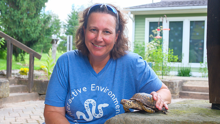 April Claus holding a turtle