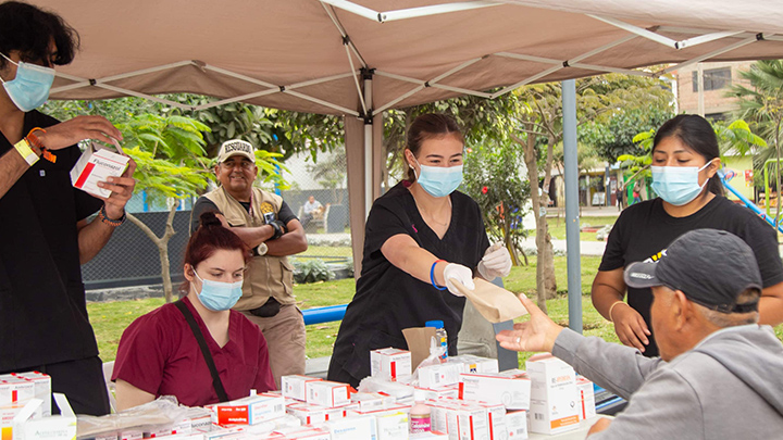Macie Johnson hands out medication at a mobile health clinic.
