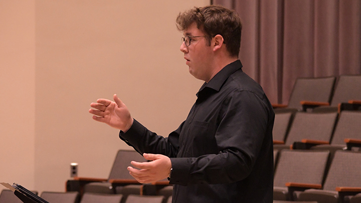 Student directing a choir