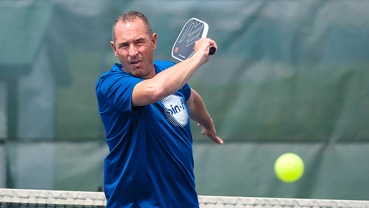 Gino Cicconi hits a pickleball shot.