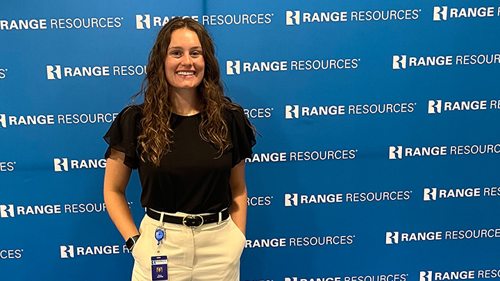 Emma Santom standing in front of a Range Resources backdrop.