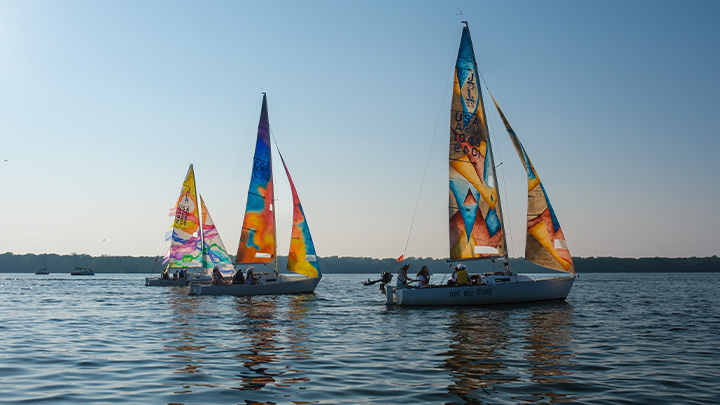 Three sailboats with sail cloths designed by SRU students.