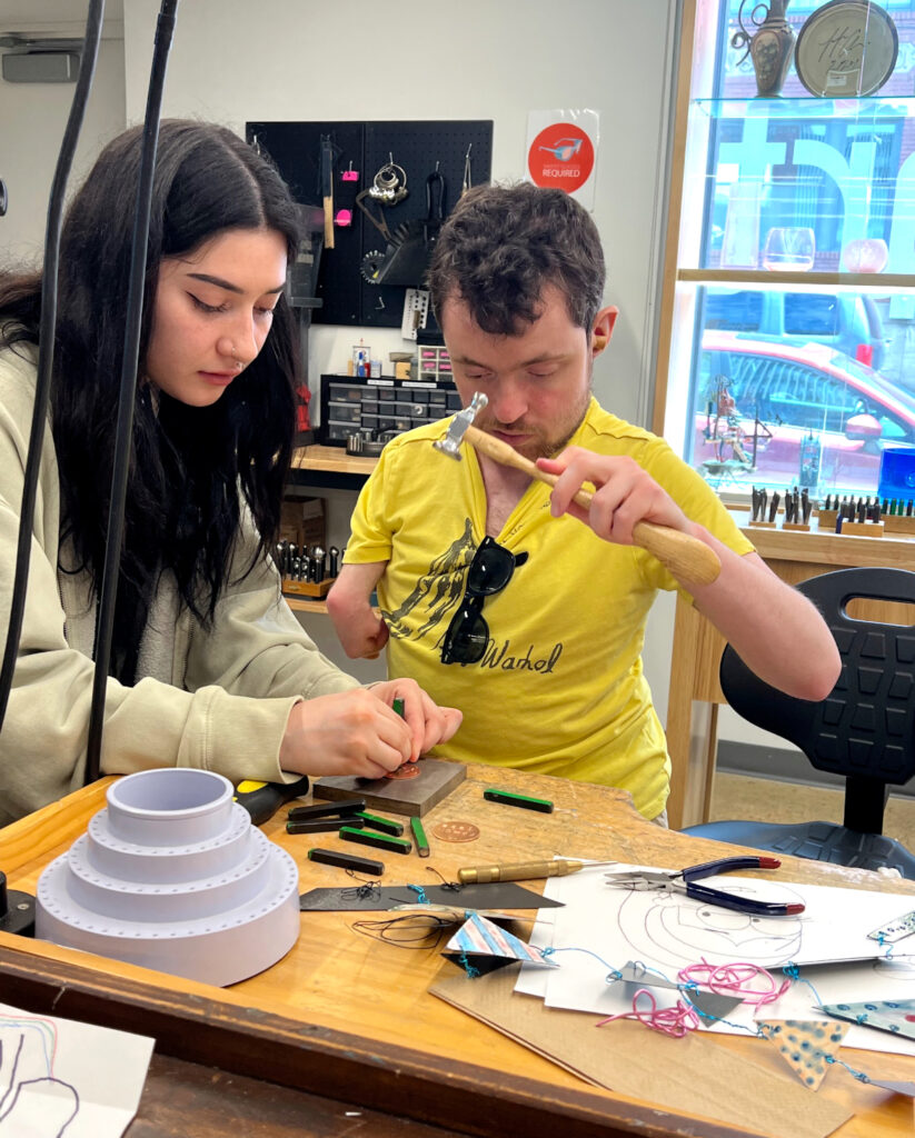From left, Alexa Rivero assists an artist at Creative Citizen Studios with etching work.