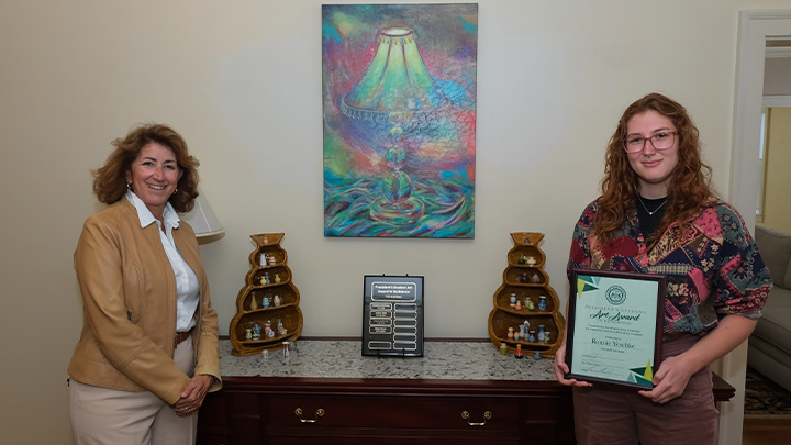 From left, SRU President Karen Riley presents Veronica Yeschke the President’s Student Art Award in Residence. Yeschke’s artwork will be displayed in the foyer of Riley’s home on campus.