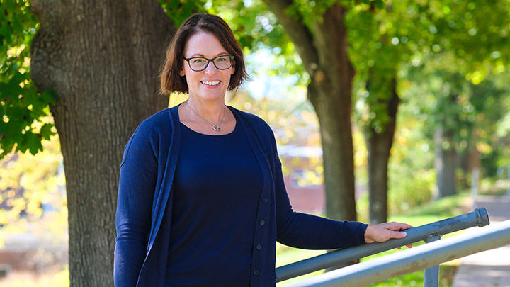 Tami Micsky standing in front of a tree on campus.