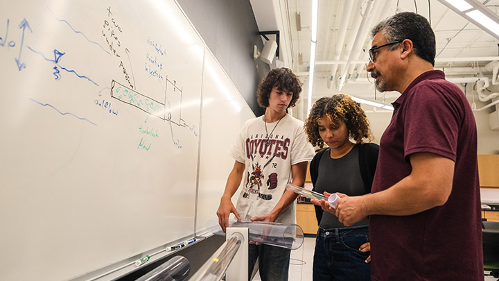 From left, SRU students John Westwood and Rachell Lajara Flores work with Sajad Hamidi, associate professor of engineering, on a wastewater mixing research project which includes a small-scale replica of a treatment plant using pipes in a laboratory on campus.