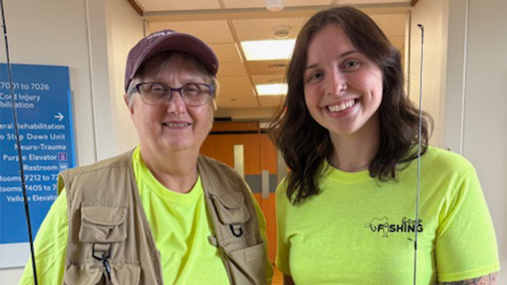 From left, SRU alumni Charlene Subrick and Grace Laudenslager posing with fishing poles and vests.