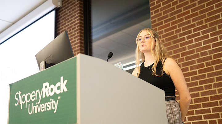 Student at a podium presenting.