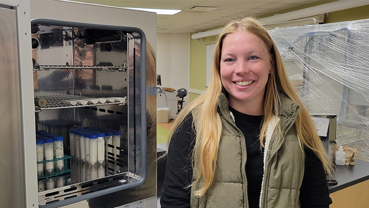 Student in a lab with samples.