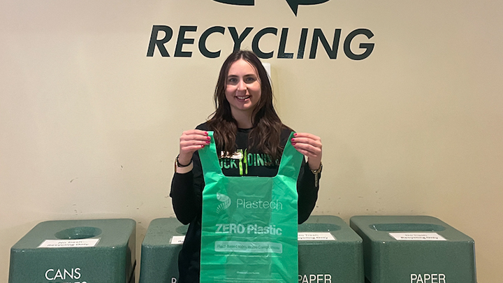 Studnt holding a corn starch bag alternative.