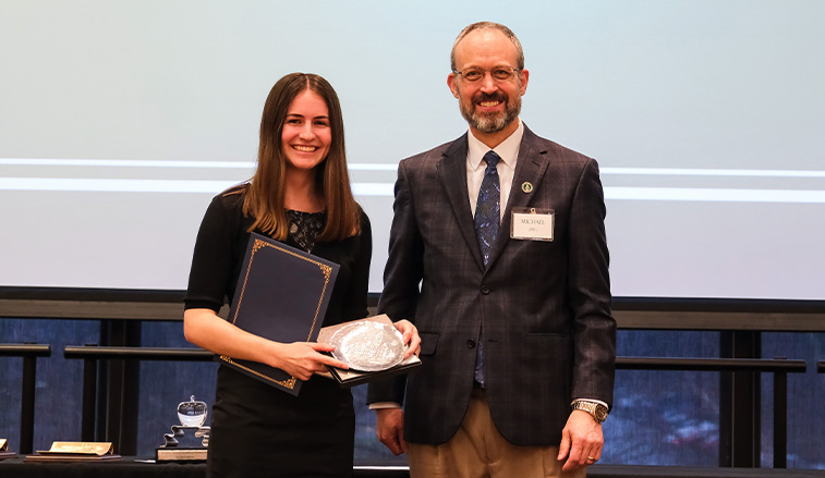 Kelli Galbraith receiving an award from Michael Zieg