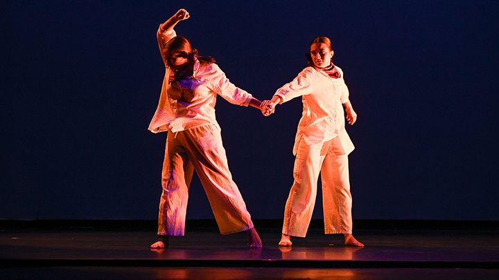 Two dancers holding hands