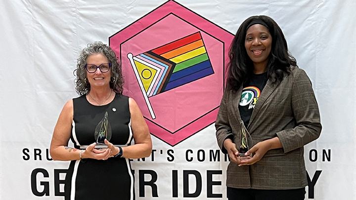 From left, Bonnie Siple, professor of athletic training, and Keshia Booker, interim vice president for campus culture and climate, accept the Unity Prism Award at the NightOUT celebration, April 9, in the Smith Student Center Ballroom.