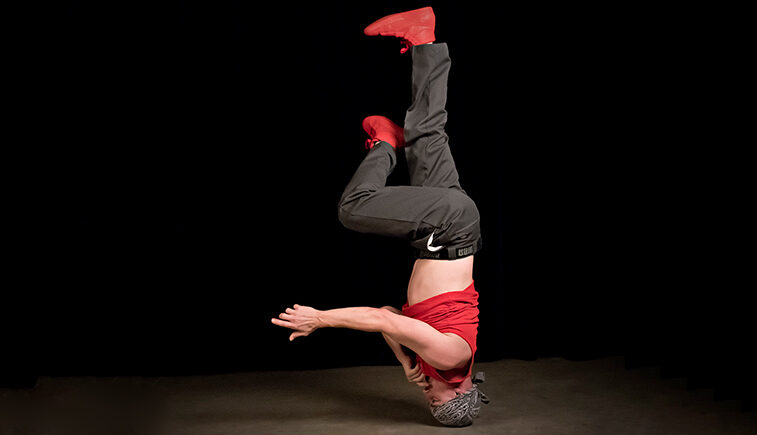 Student does a breakdance headspin.