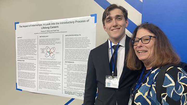 From left, SRU hospitality and tourism major Charles Reilly with Sheryl Kline, deputy dean and professor hospitality and sport business management at the University of Delaware, poses with Reilly’s poster at the NENA-CHRIE conference in Atlantic City.