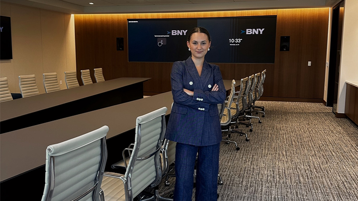 Krislyn Green standing arms crossed in a conference room at BNY mellon