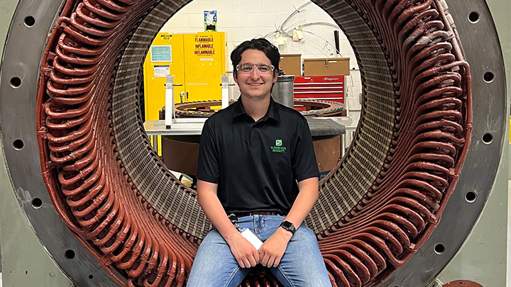 Nathan Sharp, an SRU physics and mechanical engineering major, sits in the stator of a generator at Westinghouse Electrical plant during his internship working in the fluid systems department.