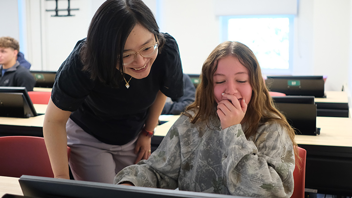 Xintong Wang guides students in her econometrics class at SRU.