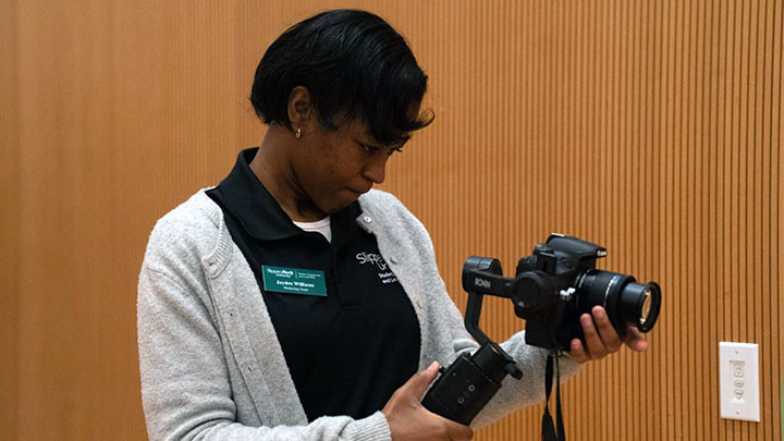 Student holding a camera.