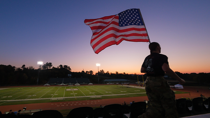ROTC cadet with the American flag.