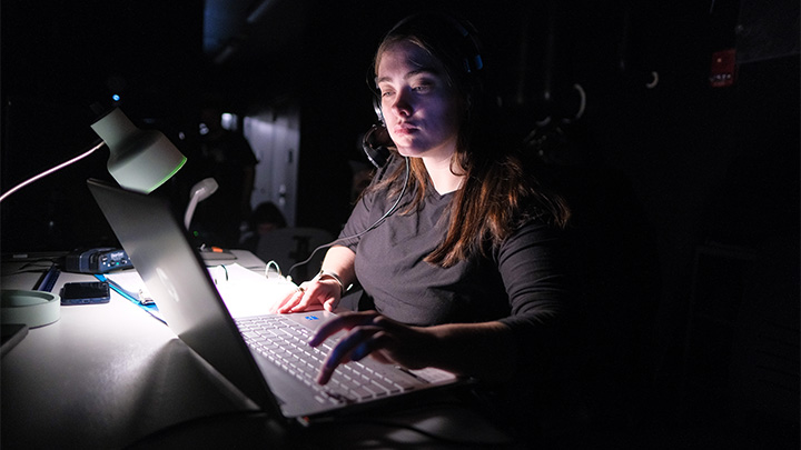 Stage managers Brittany Walsh (above in booth) snf Alyssa Starkey (inset) are on headsets during productions communicating with the crew.
