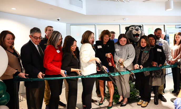 Karen Riley cuts the ribbon with other contributors to the new Success Center