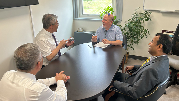 From left, Tony Nie, vice president and dean of the School of International Education at Quanzhou University of Information Engineering, is presented a novelty gift, a branded SRU rock, by Tim Slekar, SRU’s associate provost for academic innovation and dean of graduate and continuing education, while also meeting with Prasad Vemala, dean of SRU’s College of Business.