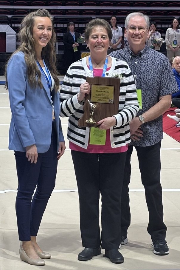 Center, Maria Bachuchin was recognized by the Indiana High School Athletic Association as its Official of the Year at the 2025 Gymnastics State Finals meet.