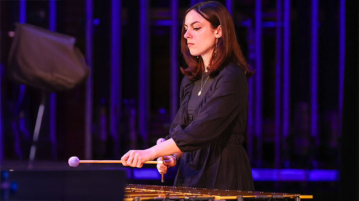 Woman playing a xylophone.