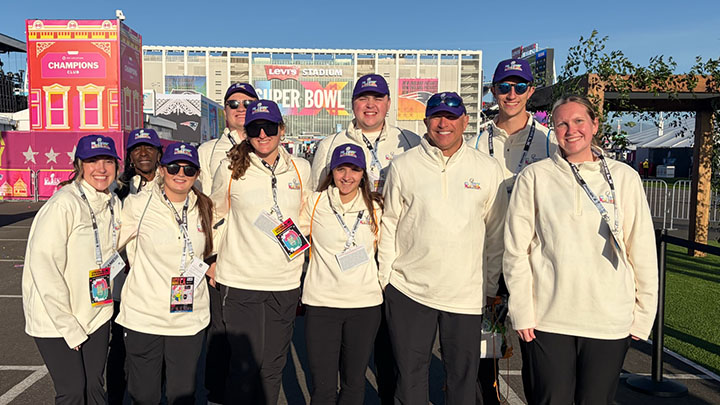 Group of Super Bowl workers standing outside the stadium.