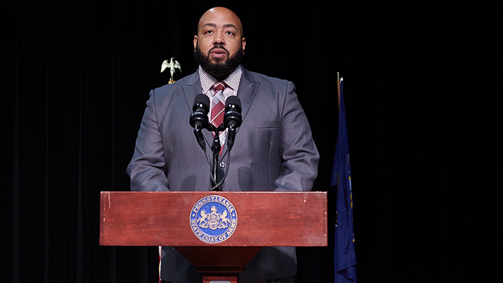 Man standing at a podium.