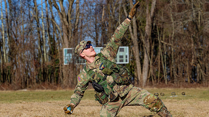 ROTC Cadet throwing a dummy grenade as part of a competition event.