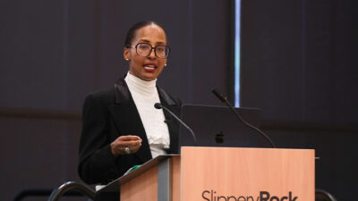 Woman speaking at a podium.