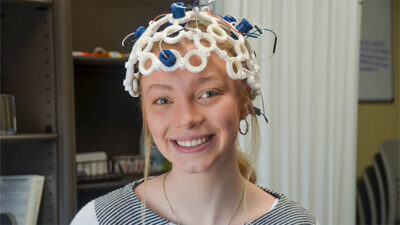 Carmella Ryan wears an electroencephalogram monitor that is used in a cognitive neuroscience research study at Slippery Rock University. Ryan and Shannon McKnight, instructor of psychology, built and programmed the monitor.