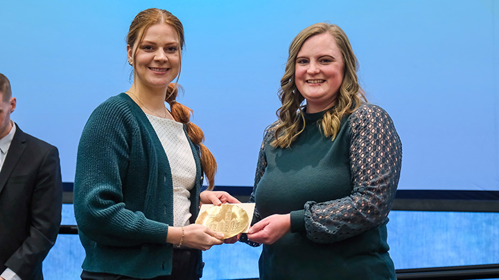 From left, Lizzy Kline, assistant director of wellness education, is presented the Emerging Leader Award, by Amanda Nichols, a member of the Pillar One Awards Committee.