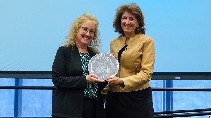 From left, Yvonne Eaton-Stull, associate professor of social work, is presented the 2026 Community Service Scholar Award by SRU President Karen Riley.