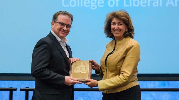 From left, Brian Sateriale, instructor of languages, literatures, cultures, and writing, is presented the 2026 President’s Award for Excellence in Teaching (Non-Tenure Track) by SRU President Karen Riley.