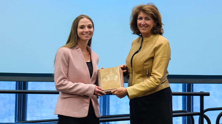 From left, Maureen Walsh, assistant professor of exercise science, is presented the 2026 President’s Award for Advising Excellence (Emerging Category) by SRU President Karen Riley.