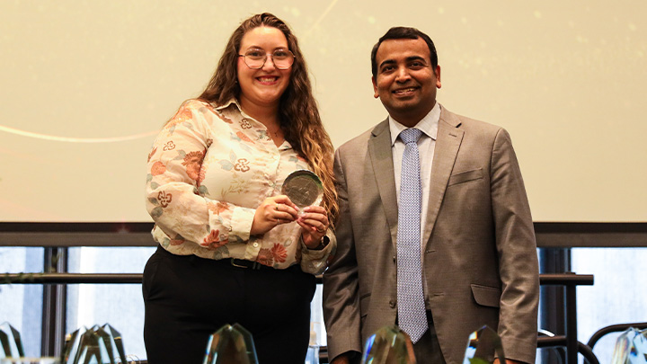 From left, Paige McCullough, a senior communication major from Erie (McDowell HS) is awarded the Haverlack College of Business’ Outstanding Student Academic Leader award by Dean Prasad Vemala.