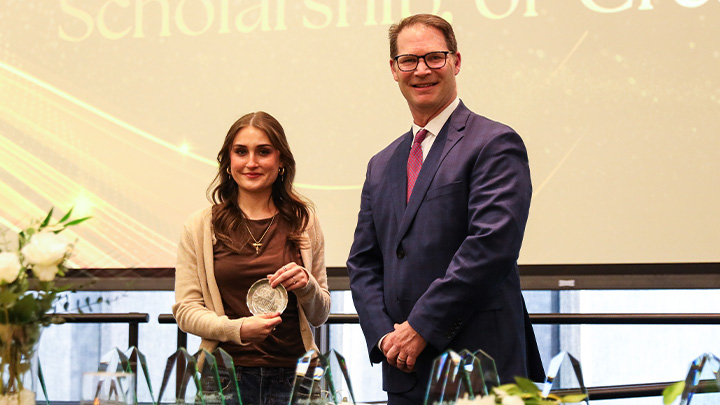 From left, Autumn Crawford, a junior early childhood education major from Coatesville (Downingtown HS), is awarded the College of Education’s Outstanding Student in Research, Scholarship or Creative Activity award by Dean Keith Dils.