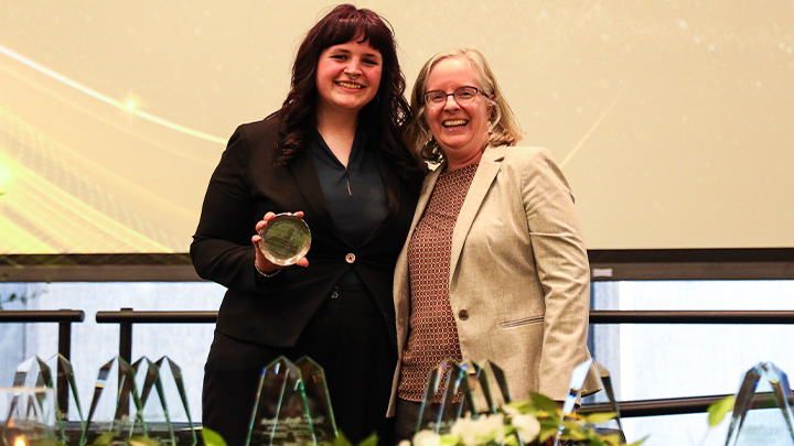 From left, Audrey Schubert, a senior physics major from Pittsburgh (Northgate HS), is awarded the College of Engineering and Science’s Outstanding Student in Research, Scholarship or Creative Activity award from Dean Nicole Dafoe.