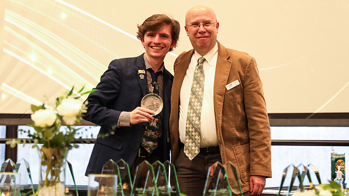 From left, Jacob Onoffrey, a senior music education major from Greensburg (Hempfield HS), is awarded the College of Liberal Arts’ Outstanding Student Academic Leader award from Dean Dan Bauer.